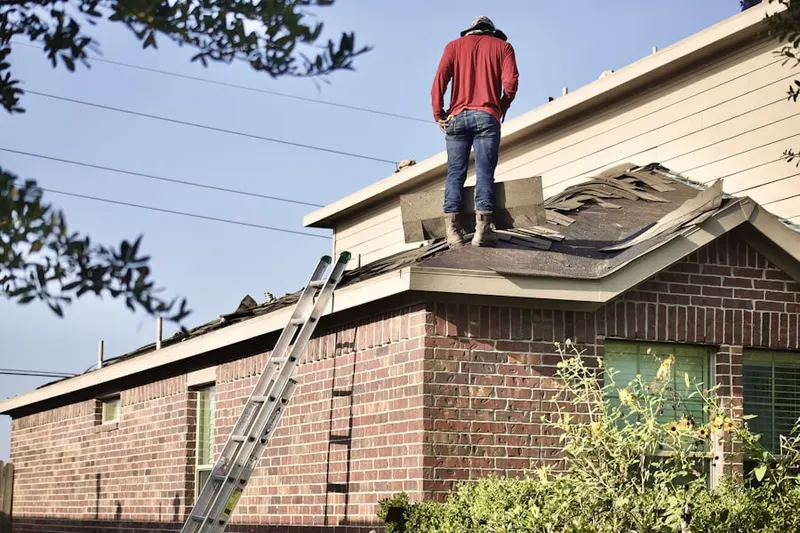 Professional roofer working on a residential roof in Trooper